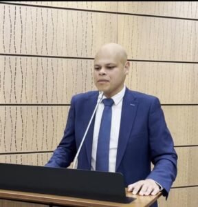 Jamil Jivani speaking at a podium in Parliament, May 2025