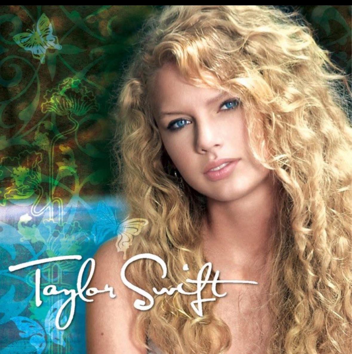 Young Taylor Swift with curly blonde hair and blue eyes in early album artwork
